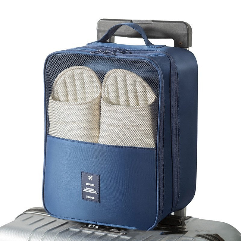 Travel Shoe Storage Bag with two pairs of shoes organized in a waterproof compartment on a suitcase.