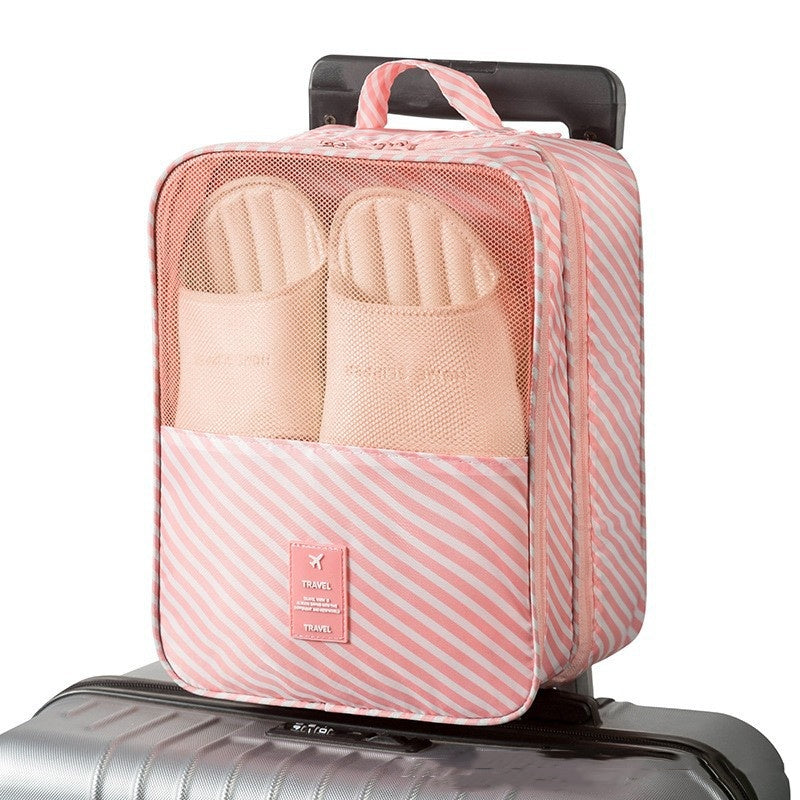 Travel Shoe Storage Bag organizing shoes in a pink striped waterproof travel bag.
